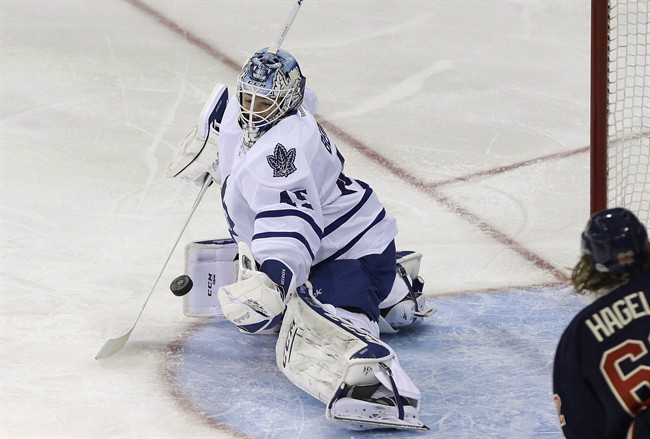 Toronto Maple Leafs goalie Jonathan Bernier deflects a shot during the third period of an NHL hockey game Wednesday, March 5, 2014,