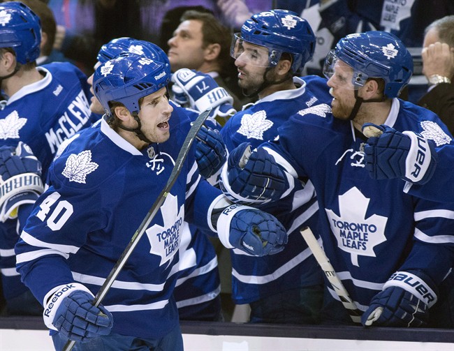 Toronto Maple Leafs winger Troy Bodie (40) is congratulated by teammates Nazem Kadri (centre) and Phil Kessel (right) after scoring on Phoenix Coyotes goaltender Mike Smith during first period NHL action in Toronto on Thursday December 19, 2013. 