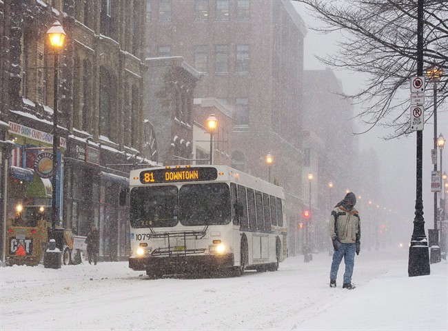 A man walks through the snow on a downtown street in Halifax on Wednesday, Jan. 22, 2014. 