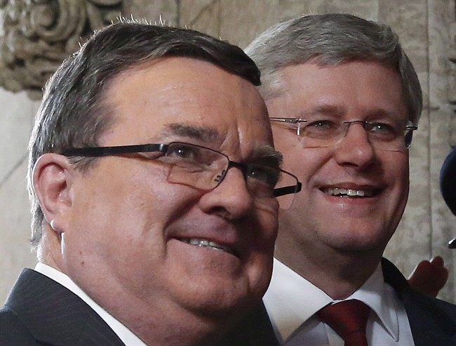 Finance Minister Jim Flaherty and Prime Minister Stephen Harper enter the House of Commons on budget day on Parliament Hill in Ottawa on Tuesday, February 11, 2014.  Flaherty passed away suddenly in Ottawa on Thursday.