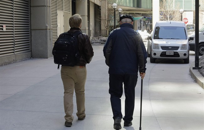 In this Feb. 28, 2014 photo, first-year Northwestern University medical student Jared Worthington, left, walks with his "Alzheimer's buddy," retired physician Dan Winship in Chicago.