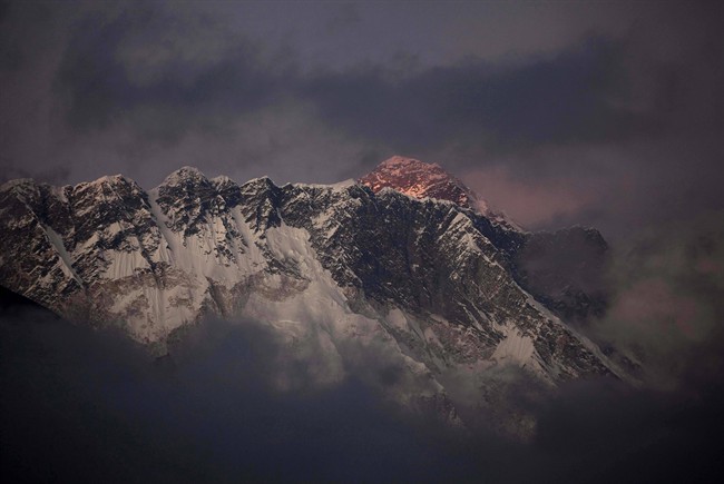 In this Oct. 27, 2011 file photo, the last light of the day sets on Mount Everest as it rises behind Mount Nuptse as seen from Tengboche, in the Himalaya's Khumbu region, Nepal.