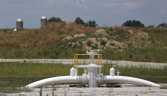 A valve extends above ground at the Enbridge Key Terminal near Salisbury, Mo., July 16, 2013. THE CANADIAN PRESS/AP, Orlin Wagner.