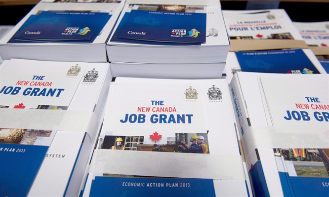 Copies of the Federal Budget and Canada Job Grant fliers are pilled on a desk on Parliament Hill in Ottawa on March 21, 2013.