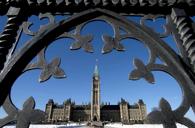 Centre Block is shown through the gates of Parliament Hill in Ottawa .