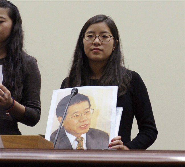 Ti-Anna Wang holds a photo of her father Wang Bingzhang, prior to testifying before the House Foreign Affairs Committee in Washington, Dec. 5, 2013.