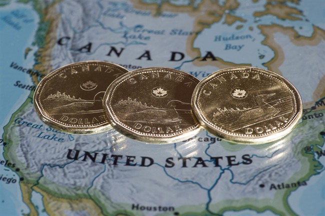 Canadian dollar coins, or Loonies, are displayed on a map of North America .