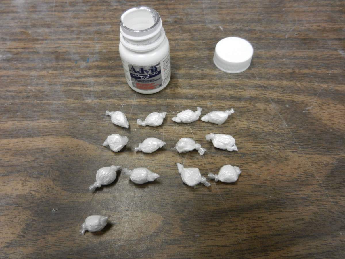 Police seize approx. 34 individually wrapped bags of cocaine, along with about $15,000 in cash during a drug bust west of Edmotnon, Thursday, Mar. 27, 2014. 