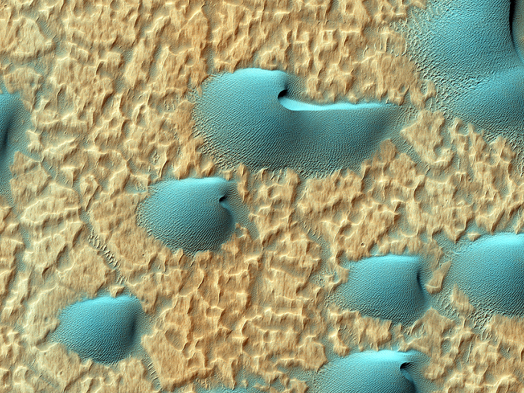 A turquoise field of dunes lies on the floor of one of the oldest places on Mars, the Noachis Terra crater. This isn't how we'd see the dunes: infrared has been added to this image to create the colour.