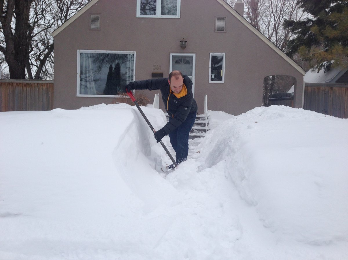 Neil Fitzpatrick shovels snow on his two year wedding anniversary. It was 19 C when he was married March 17, 2012.