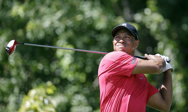 Tiger Woods tees off on the third hole during the final round of the Honda Classic golf tournament on Sunday, March 2, 2014, in Palm Beach Gardens, Fla. 