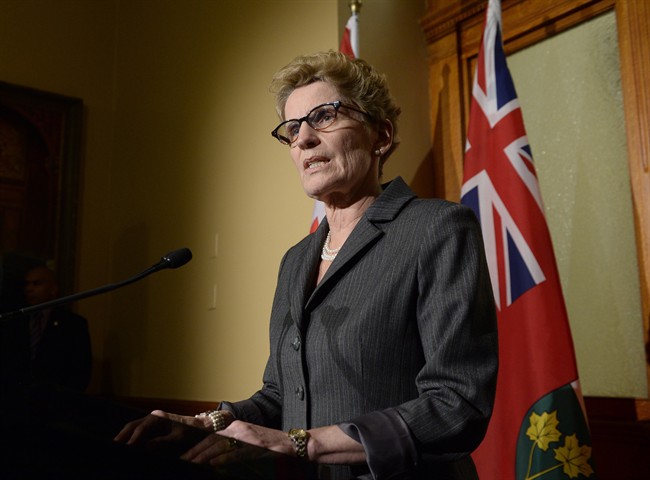 Ontario Premier Kathleen Wynnes talks to media outside her office at Queen's Park in Toronto on Thursday, March 27, 2014.