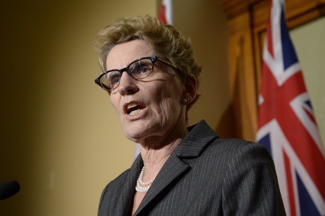 Ontario Premier Kathleen Wynnes talks to media outside her office at Queen's Park in Toronto on Thursday, March 27, 2014.