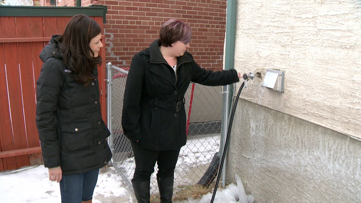 Toni Provost explains how a garden hose is used to connect her home with neighbour’s water.