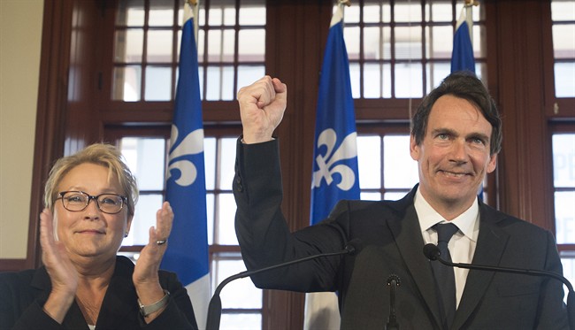 Parti Quebecois leader Pauline Marois looks on as Pierre Karl Peladeau gestures during a press in Saint Jerome, Que., Sunday, March 9, 2014. Peladeau has announced his candidacy for the riding of Saint Jerome for the Parti Quebecois on day five of the Quebec provincial election campaign.