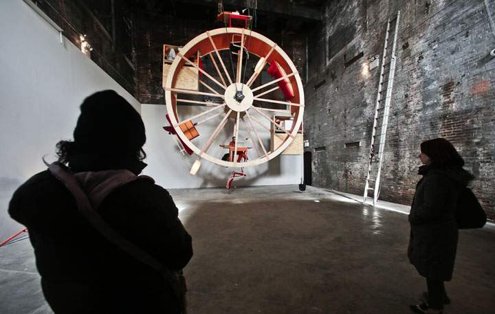 Visitors view the performance art "In Orbit," at the Boiler gallery in Williamsburg, N.Y. on March 4, 2014. 