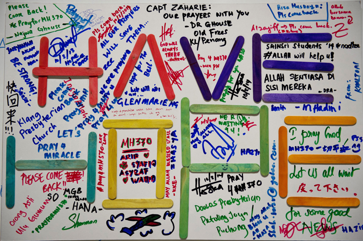 A poster carrying messages for the passengers of the missing Malaysia Airlines Boeing 777-200 plane is seen at the Kuala Lumpur International Airport (KLIA) in Sepang on March 10, 2014.