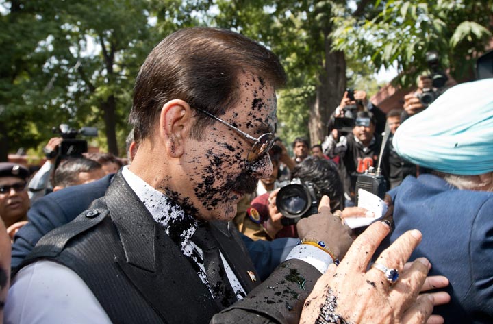 India's Sahara group chairman Subrata Roy's face is covered in black ink as he arrives at the Supreme Court in New Delhi on March 4, 2014 .