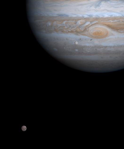 Europa, seen against Jupiter, with another of Jupiter's many moons, Callisto.
