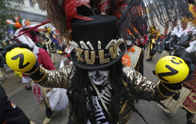 Members of the Krewe of Zulu march during Mardi Gras day in New Orleans, Tuesday, March 4, 2014. 