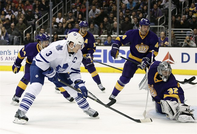 Toronto Maple Leafs' Dion Phaneuf, left, scores against Los Angeles Kings goalie Jonathan Quick during the first period of an NHL hockey game on Thursday, March 13, 2014, in Los Angeles.(AP Photo/Jae C. Hong).