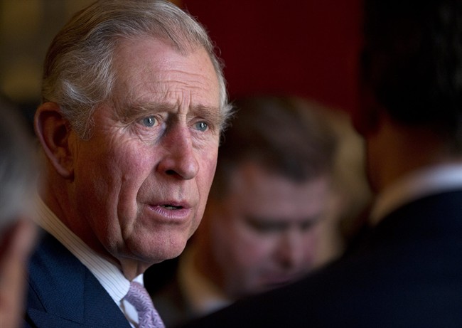 FILE - This is a Wednesday, Dec. 11, 2013 file photo of Britain's Prince Charles, talks to people at a reception following the ceremony to award The Prince of Wales Medal for Philanthropy for 2013, in London.