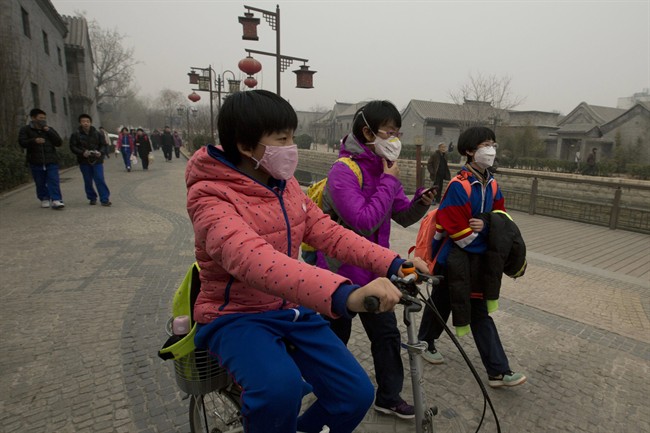 Children wearing masks walk home after school in Beijing, China on Feb. 25, 2013.