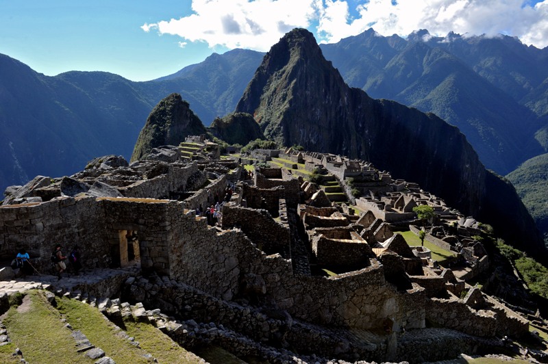 Tourists walk among the ruins of the Machu Picchu citadel, 130 km northwest of Cusco, Peru on July 6, 2011. The Inca compound is being prepared for the centennial commemoration of its discovery by American adventurer and archaeologist Hiram Bingham in 1911. Machu Picchu recognized as a World Wonder in 2007 sits at 2,350 meters above sea level in the heart of the Urubamba valley in southern Peru, 510 kilometers south of Lima. AFP PHOTO/Cris BOURONCLE .