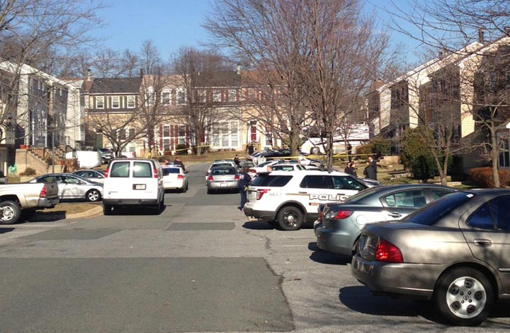 This photo taken with a cellphone camera shows police on the scene outside a home in Germantown, Md., Friday, Jan. 17, 2014, where two children were found dead and two children and an adult were found injured. 