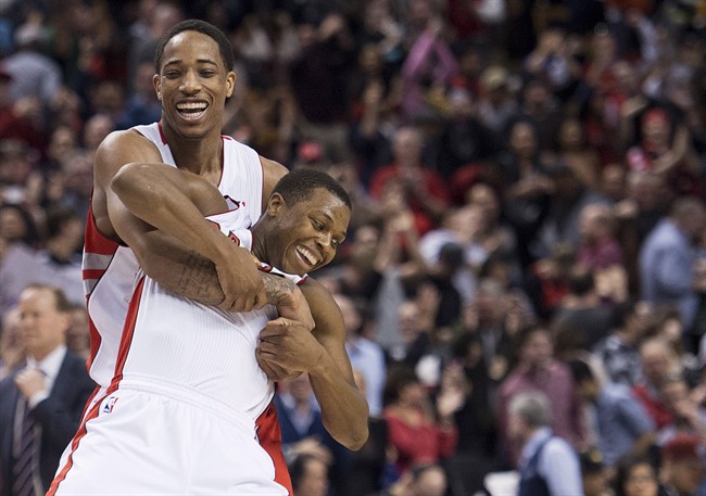 Toronto Raptors teammates DeMar DeRozan, left, and Kyle Lowry, right, celebrate after defeating the Atlanta Hawks 96-86 in NBA action in Toronto on Sunday, March 23, 2014. THE CANADIAN PRESS/Nathan Denette.