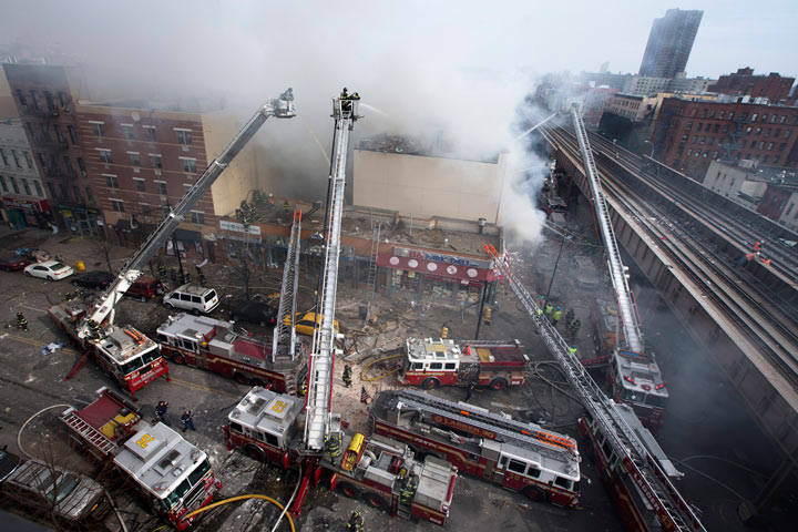 Firefighters battle a fire after a building collapse in the East Harlem neighborhood of New York, Wednesday, March 12, 2014 .