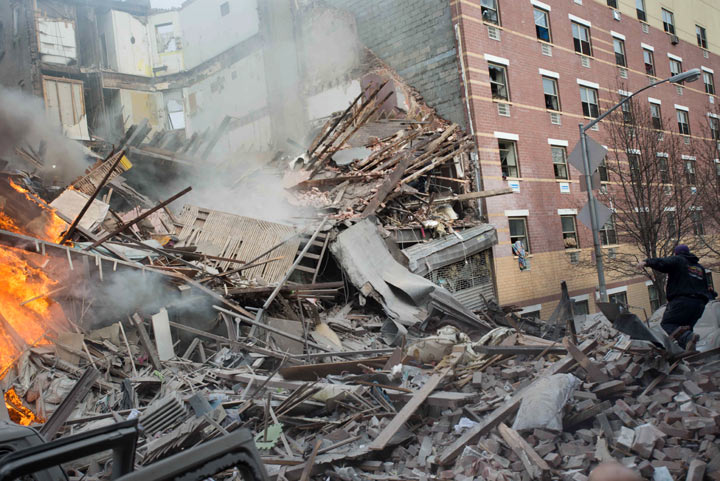 Emergency workers respond to the scene of an explosion that leveled two apartment buildings in the East Harlem neighborhood of New York, Wednesday, March 12, 2014.