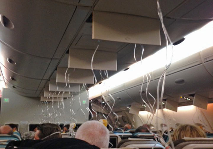 This photo taken Jan. 6, 2013 shows oxygen masks hanging from the ceiling of a Singapore Airlines Airbus A380 as it lost cabin pressure on a flight from London to Singapore. The plane made an emergency landing in Baku but no one was injured, the carrier said.
