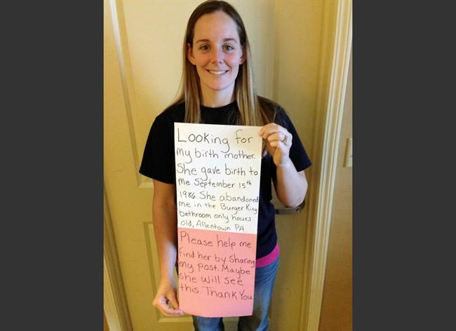 This March 2, 2014 photo provided by Katheryn Deprill that she posted on Facebook, shows her holding a sign that says she is seeking her birth mother. 