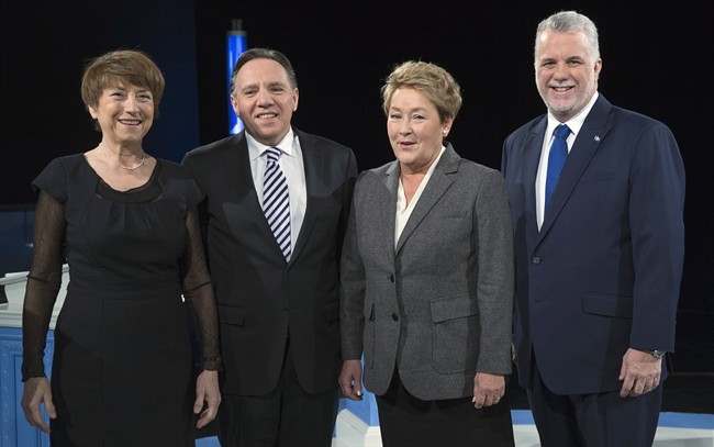 Quebec Solidaire Leader Francoise David, Coalition Avenir du Quebec Leader Francois Legault, Parti Quebecois leader Pauline Marois, and Liberal leader Philippe Couillard pose for a photograph prior to the leaders' debate Thursday, Thursday, March 20, 2014 .