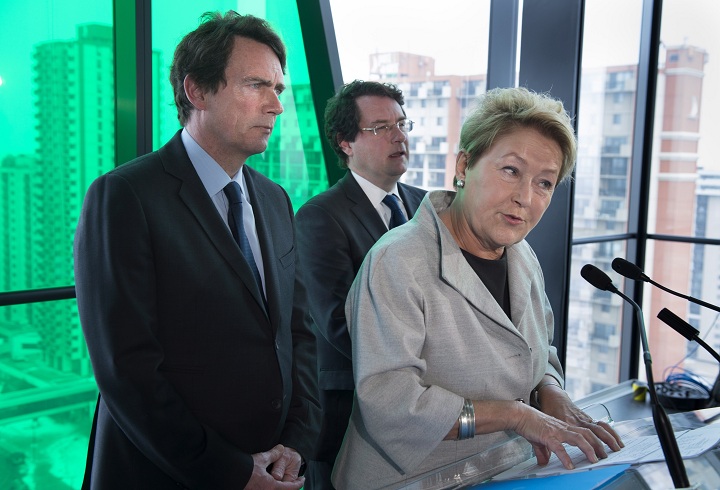 PQ leader Pauline Marois, flanked by candidates Pierre Karl Peladeau, left, and Bernard Drainville reponds to a question during a news conference Friday, March 21, 2014 in Longueuil, Que.