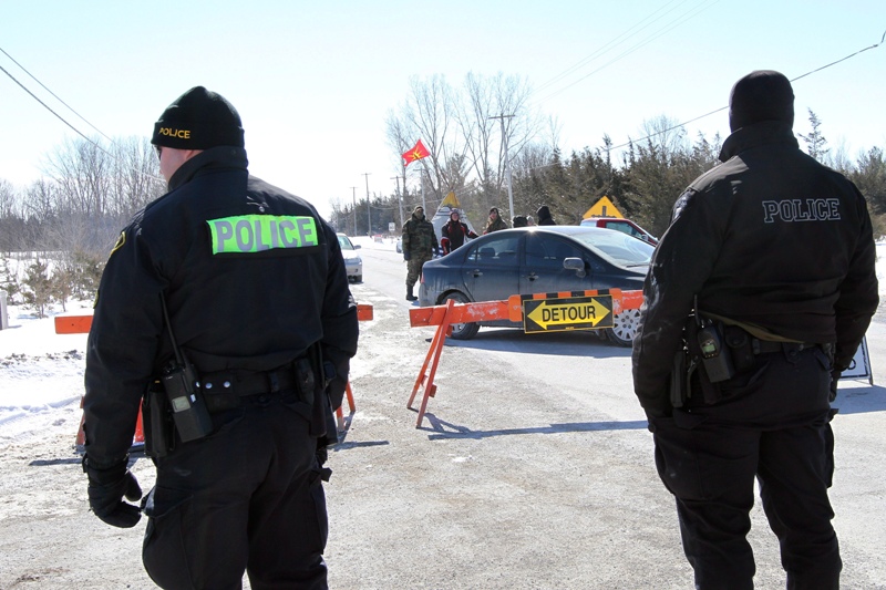 OPP officer keep an eye on the native road protest near Shannonville, Ont., on Monday March 3, 2014. The protest is led by Shawn Brant, who wants a national inquiry into missing and murdered native women. THE CANADIAN PRESS/Lars Hagberg.