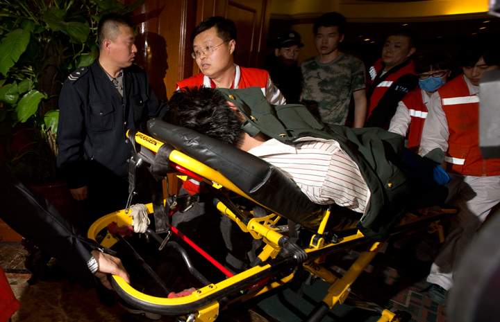 A relative of one of the Chinese passengers aboard the Malaysia Airlines, MH370 is taken away on a stretcher after being told of the latest news in Beijing, China, Monday, March 24, 2014.