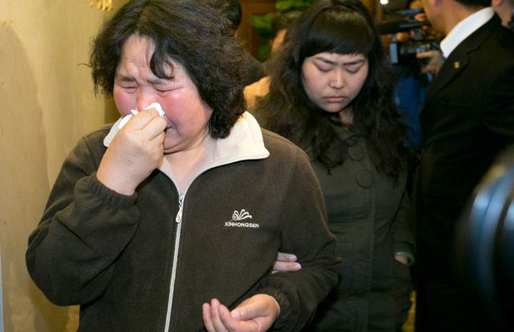 Relatives of Chinese passengers aboard the Malaysia Airlines jet, MH370, grieve after being told of the latest news in Beijing, China, Monday, March 24, 2014.