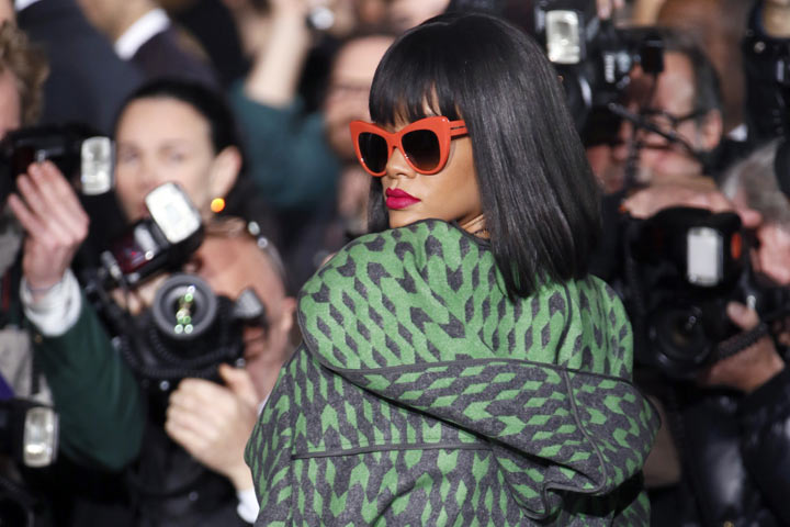 Rihanna poses as she arrives to attend Stella McCartney