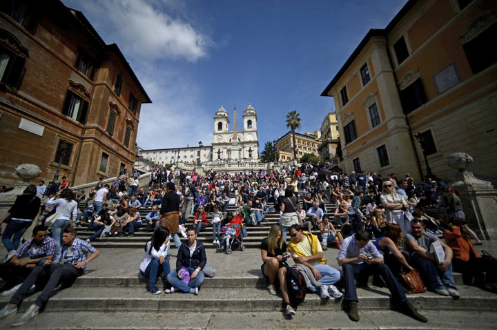 Tourists sit on the Spanish steps in downtown Rome on April 5, 2012. 