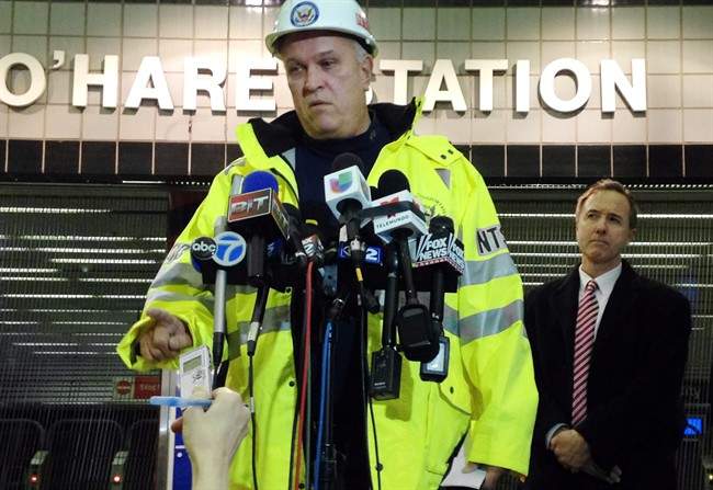 Tim DePaepe, an investigator with the National Transportation Safety Board, accompanied by Chicago Transit Authority President Forrest Claypool, right, speaks during a news conference Monday, March 24, 2014, at Chicago’s O’Hare International Airport in Chicago. The NTSB is leading an investigation into why an eight-car Chicago public-transit train jumped the tracks, skidded across a platform and scaled an escalator that leads to one of the nation\’s busiest airports early Monday, injuring 32 people. (