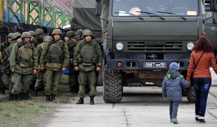 Military personnel stand near a Russian-made Kamaz truck  in the eastern Crimea'a port city of Feodosiya on March 2, 2014. 