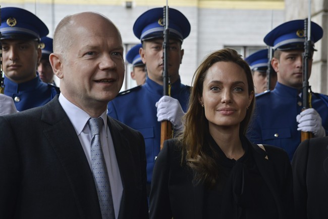 UNHCR goodwill ambassador Angelina Jolie and British Foreign Secretary William Hague pose for photographers upon their arrival for a meeting with the Bosnian Presidency in Sarajevo, Bosnia, on Friday March 28, 2014. 