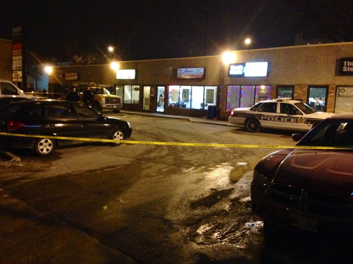 Police investigate at a Sargent Avenue strip mall near Young Street after shots were fired Wednesday night.