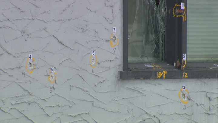 Police marks highlight bullet holes in the front of 509 Seven Oaks Avenue on Monday morning.