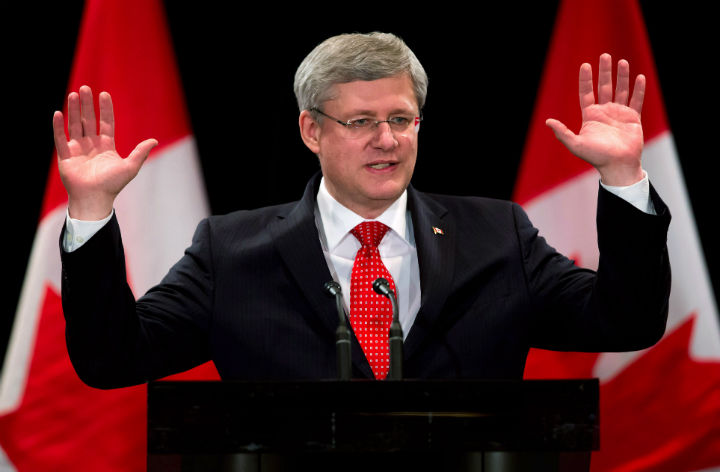 Prime Minister Stephen Harper gestures as he says a greeting in Korean before addressing members of the Korean-Canadian community during a reception in Burnaby, B.C., on Wednesday March 12, 2014. The Prime Minister is said to have given up his cellphone when he took office in 2006.