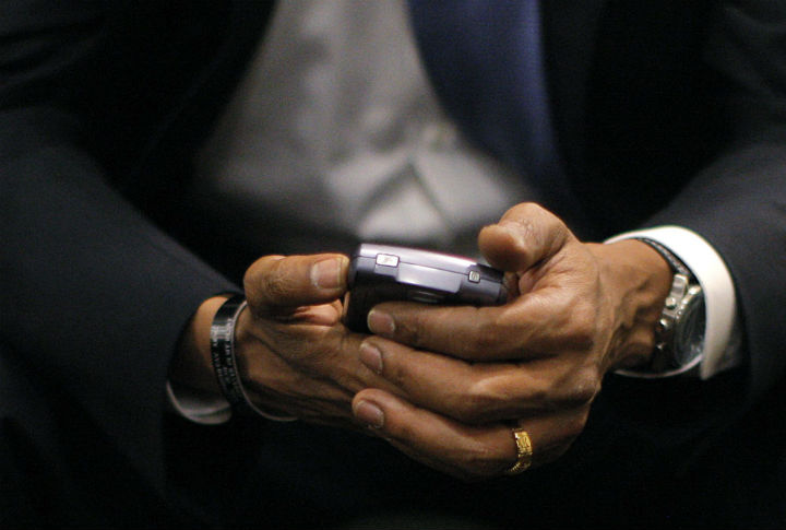 Then-Democratic presidential candidate, Sen. Barack Obama, D-Ill., checks his BlackBerry in St. Louis, in July 2008. (File photo).