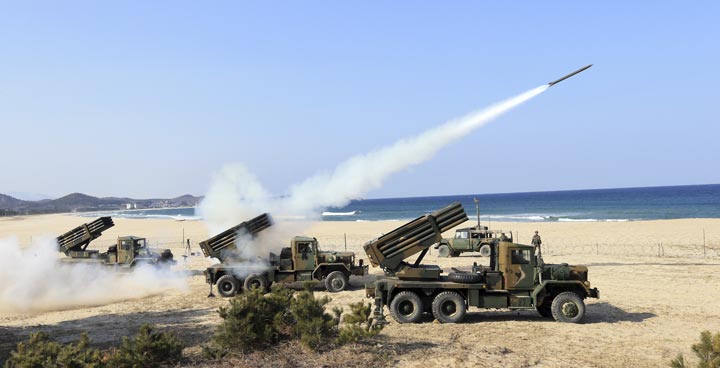 South Korean Army's 130mm multiple rocket launchers fire live rounds during an exercise against possible attacks from North Korea in Goseong, South Korea, Monday, March 3, 2014.