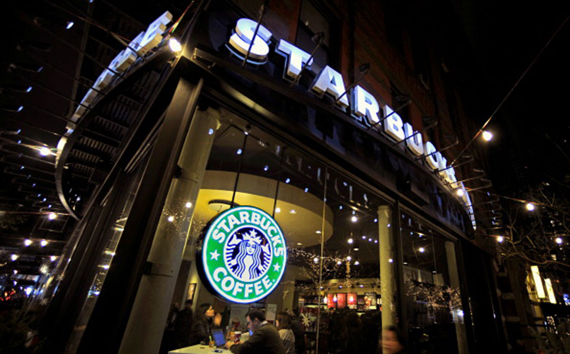 Starbucks sells beer and wine beverages in about two dozen U.S. cafes. The coffee chain says it now plans to introduce alcohol beverages in "thousands" of locations.